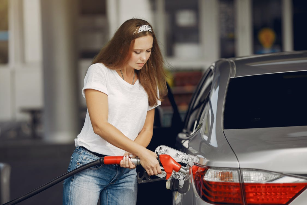 A person filing gas in their car